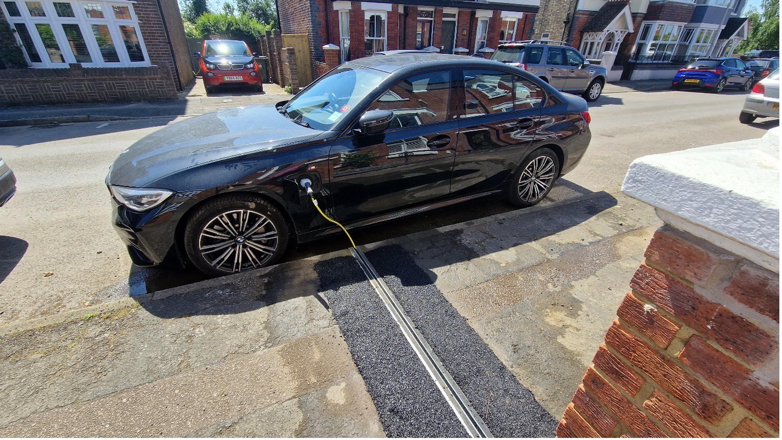 Photo of Cross Pavement EV Charging Gully with Charging Cable Inserted into Car